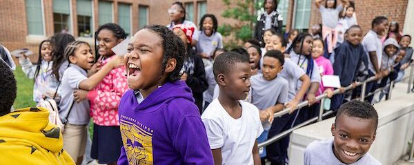 Elementary school students excited to see the Ravens players and mascot